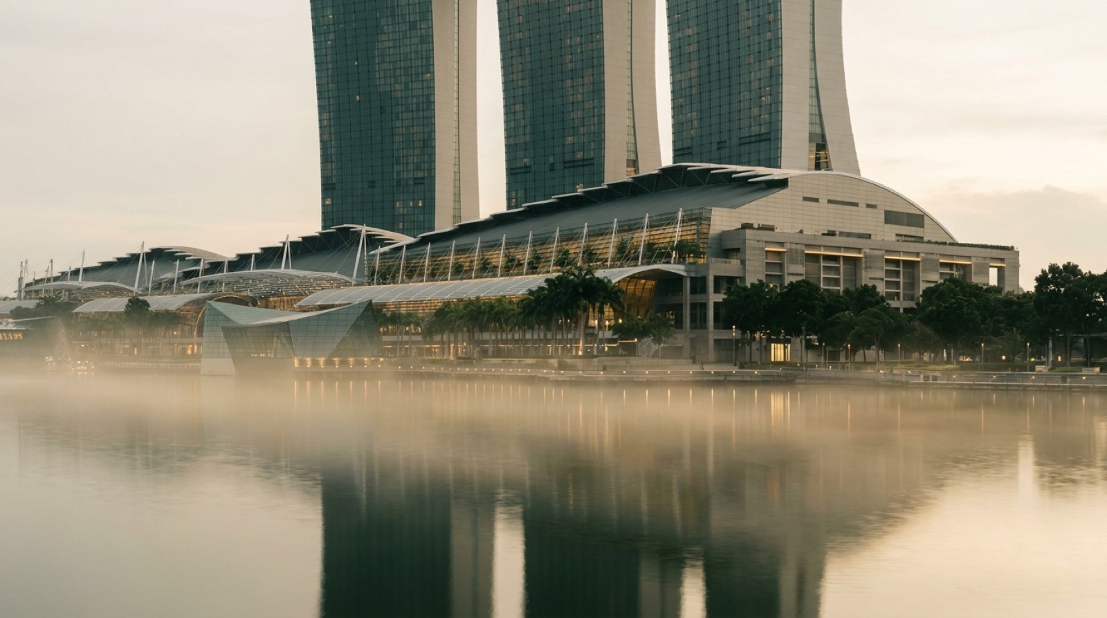 Singapore skyline at dawn across calm water